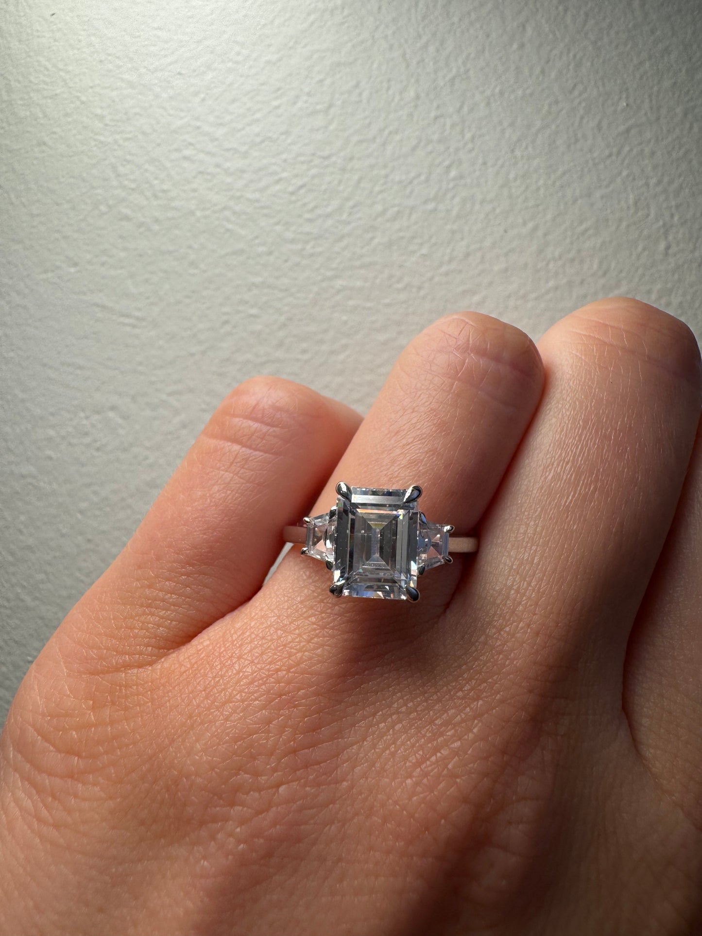 Trapezoid Trilogy Engagement Ring with Emerald Cut Diamond
