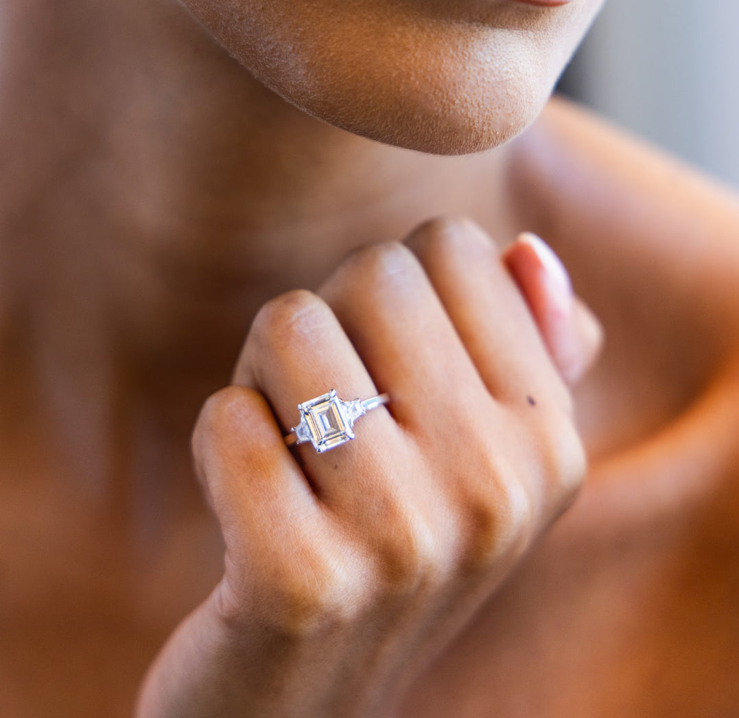 Trapezoid Trilogy Engagement Ring with Emerald Cut Diamond