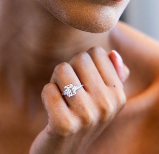 Trapezoid Trilogy Engagement Ring with Emerald Cut Diamond