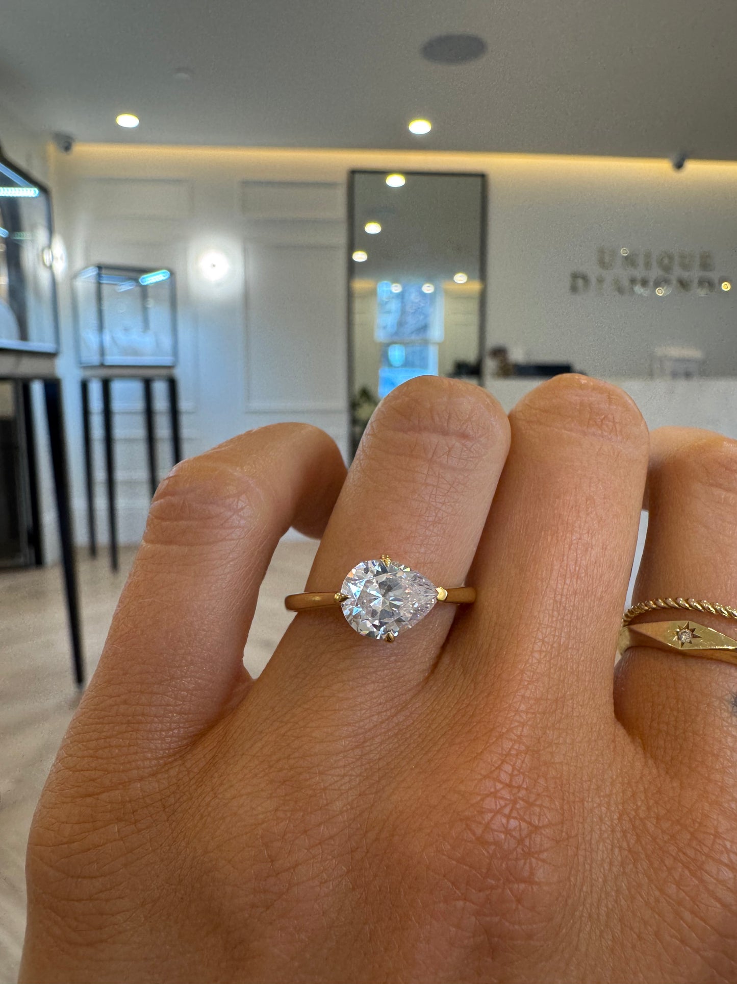 East West Engagement Ring with Pear Cut Diamond