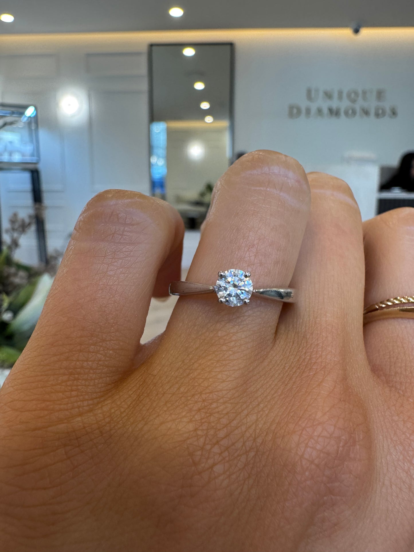 Four-Claw Tapered Solitaire Engagement Ring with Round Brilliant Cut Diamond