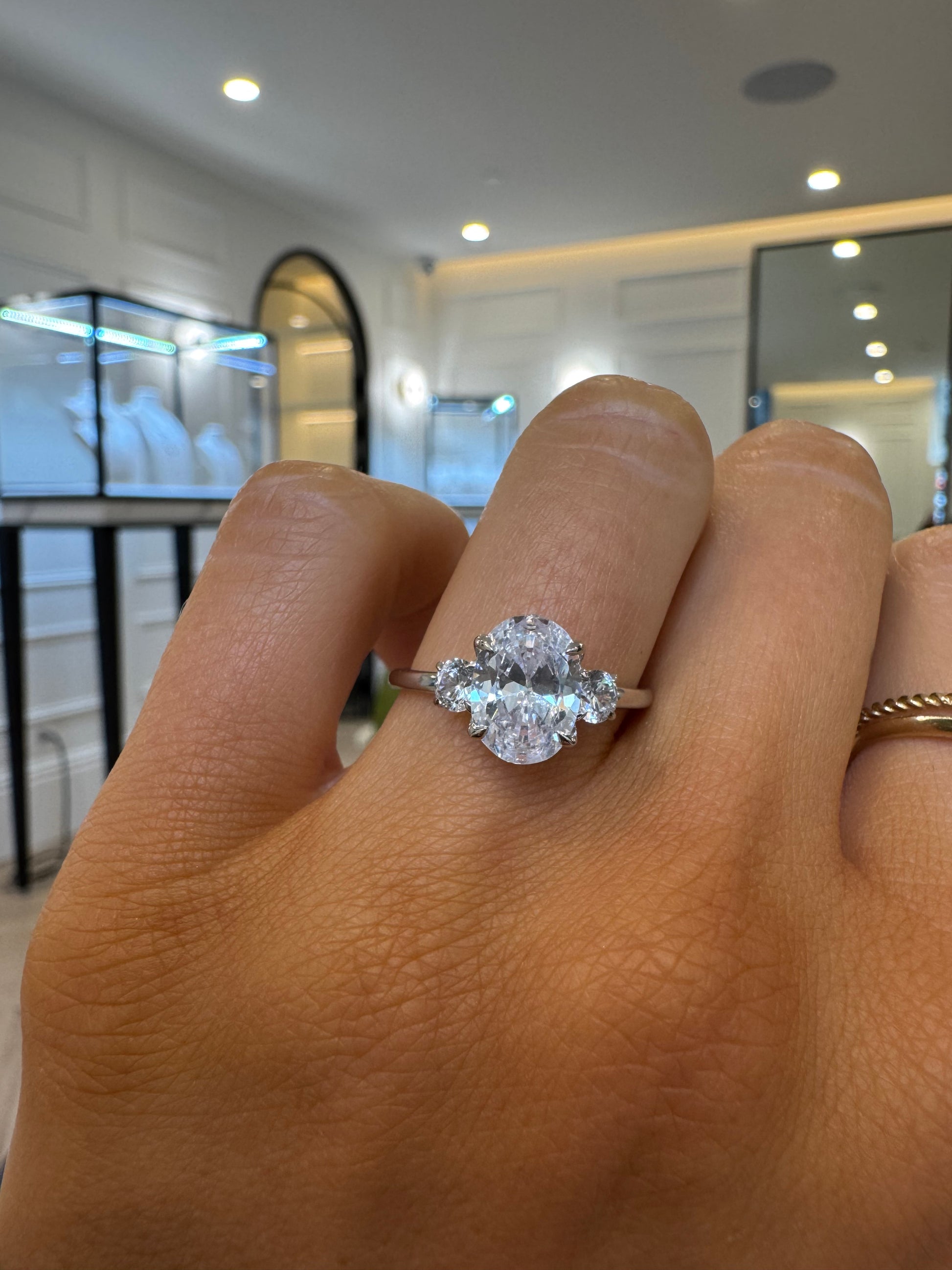 Round Trilogy Engagement Ring with Oval Cut Diamond