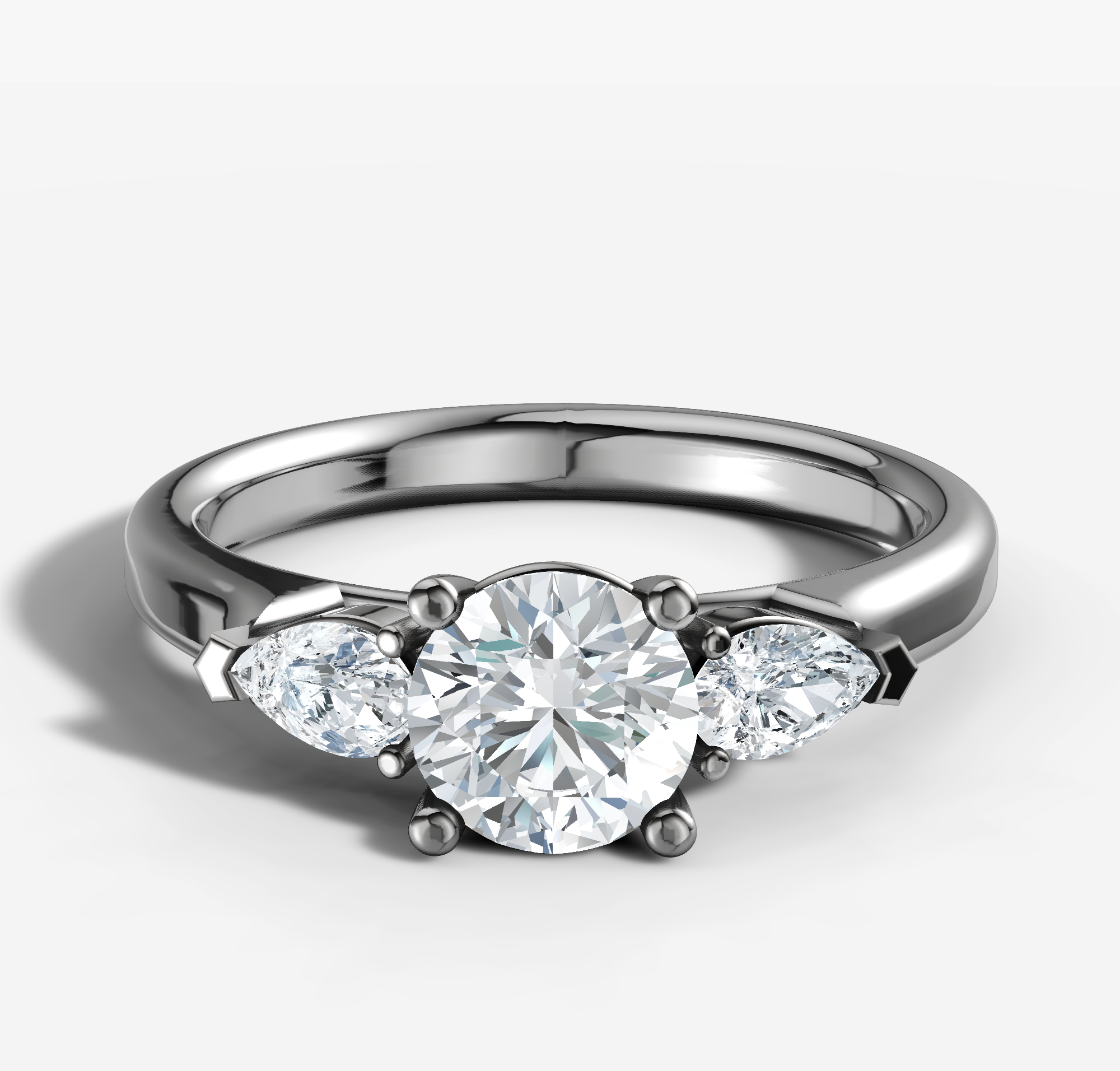 0.76ct Round Trilogy Engagement Ring with Pear Brilliant Cut Diamonds