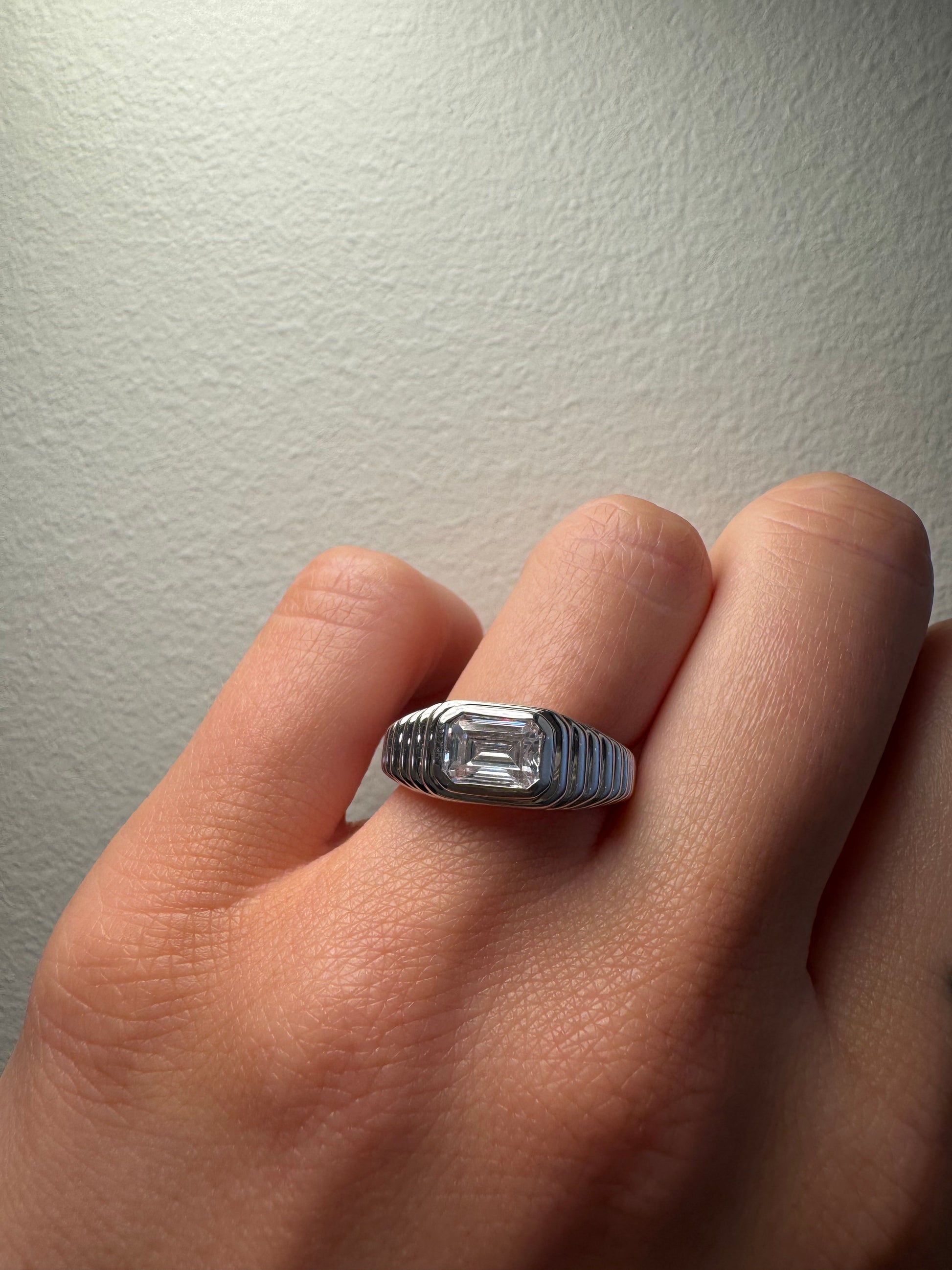 Ripple Bezel Set East West Engagement Ring with Emerald Cut Diamond